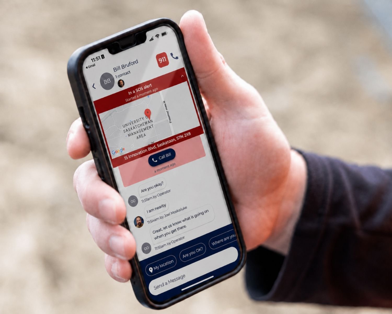 A manager holding a phone showing an active SOS alert with the location map and team messages